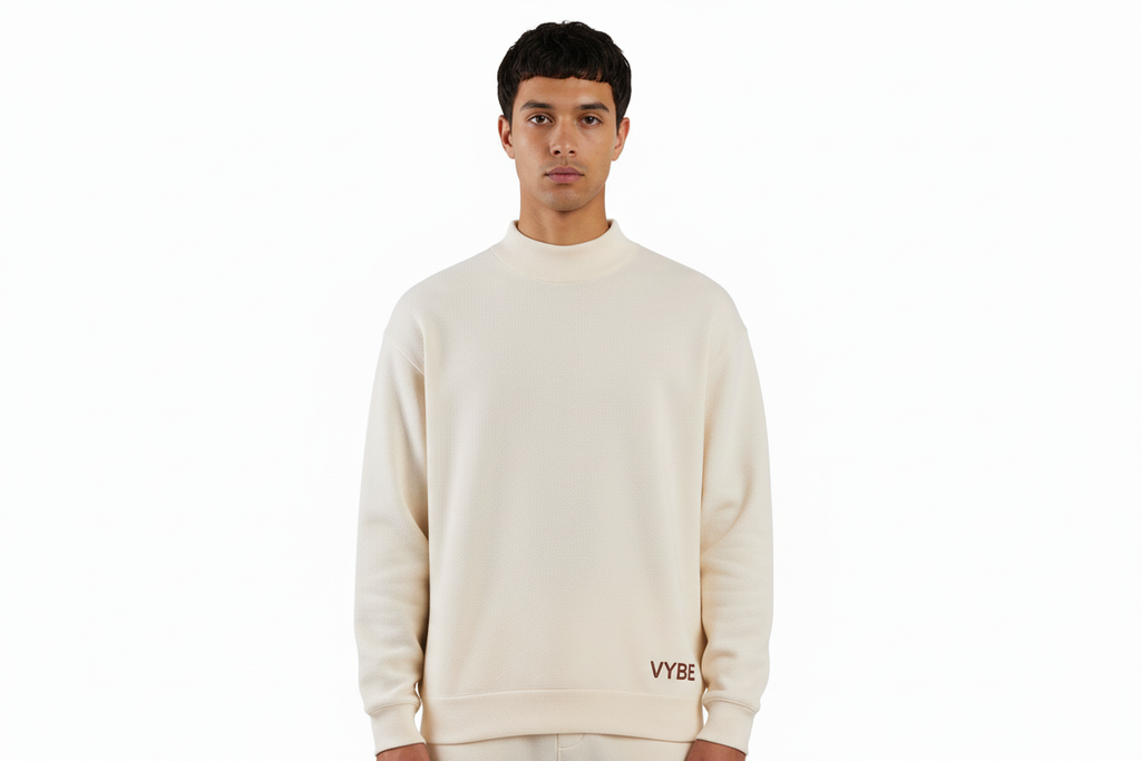 Upper body crop of cream VYBE sweatshirt